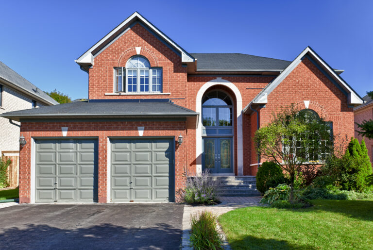 Brick house in suburbs with two car garage